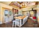 Rustic kitchen featuring an island with a wood countertop, a vintage stove, and lots of natural light at 4928 Tuckaseegee Rd, Charlotte, NC 28208
