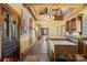 Bright kitchen featuring an island with a wooden countertop, rustic cabinets, and hardwood floors at 4928 Tuckaseegee Rd, Charlotte, NC 28208