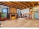 Large living room with hardwood floors, a red brick fireplace, and lots of natural light at 4928 Tuckaseegee Rd, Charlotte, NC 28208