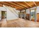 Spacious living room featuring a staircase, exposed beams, and hardwood floors at 4928 Tuckaseegee Rd, Charlotte, NC 28208