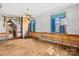 Cozy room with natural light, wood floors, vintage decor, and ample space for personalized touches at 4928 Tuckaseegee Rd, Charlotte, NC 28208