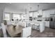 Bright open floor plan features kitchen with white cabinets, stainless steel appliances and spacious island with bar seating at 5049 Grain Orchard Rd # 3027B, Indian Trail, NC 28079