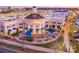Aerial view of a commercial building with blue awnings and outdoor dining options at 5672 Wrenfield Ct, Charlotte, NC 28277