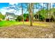 Expansive backyard featuring lush greenery, mature trees, and a charming backyard at 5672 Wrenfield Ct, Charlotte, NC 28277