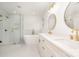 Beautiful bathroom featuring a soaking tub, glass shower, double vanity with modern fixtures and marble-look tile at 5672 Wrenfield Ct, Charlotte, NC 28277