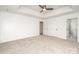 This bedroom has neutral carpet and three doors at 5672 Wrenfield Ct, Charlotte, NC 28277