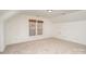 Bright bedroom with neutral carpet, white walls, two windows, and an access door at 5672 Wrenfield Ct, Charlotte, NC 28277