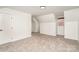 Cozy bedroom with neutral carpeting, white walls, and a window providing natural light at 5672 Wrenfield Ct, Charlotte, NC 28277