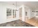 Bright dining room with a stylish chandelier, hardwood floors, and views of the backyard at 5672 Wrenfield Ct, Charlotte, NC 28277