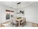 Elegant dining room featuring a large table, modern chandelier, and ample space for Gathering gatherings at 5672 Wrenfield Ct, Charlotte, NC 28277