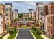 Street view of brick apartment buildings with well-maintained lawns and landscaping at 5672 Wrenfield Ct, Charlotte, NC 28277