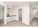 Hallway with carpet floors, multiple doorways, trim details, and a stylish chandelier at 5672 Wrenfield Ct, Charlotte, NC 28277
