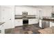 Modern kitchen featuring stainless steel appliances, white cabinetry and countertops at 5672 Wrenfield Ct, Charlotte, NC 28277