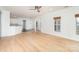 Spacious living room with hardwood floors, natural light, and an open floor plan at 5672 Wrenfield Ct, Charlotte, NC 28277