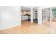 Bright living room with hardwood floors, a sliding glass door, and an open view into the kitchen at 5672 Wrenfield Ct, Charlotte, NC 28277