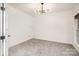 Bright office with an eye-catching contemporary light fixture, neutral carpet, and a clean, minimalist design at 5672 Wrenfield Ct, Charlotte, NC 28277