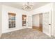 Bright office space with carpet, stylish lighting, and double glass doors offering a view to another room at 5672 Wrenfield Ct, Charlotte, NC 28277
