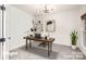 Stylish home office with a modern desk, shelving, and ample natural light for a productive workspace at 5672 Wrenfield Ct, Charlotte, NC 28277