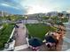 Aerial view of an outdoor gathering space with people enjoying a park-like setting at dusk at 5672 Wrenfield Ct, Charlotte, NC 28277