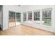 Sun-drenched room with hardwood floors, large windows, and views of the outdoor deck and backyard at 5672 Wrenfield Ct, Charlotte, NC 28277