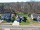 This is an aerial view of a well-maintained home with a beautiful yard surrounded by lush trees in a friendly neighborhood at 572 Church St, Locust, NC 28097
