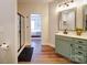 Well-lit bathroom with a large glass shower and a view to the bedroom, wood floors at 572 Church St, Locust, NC 28097