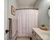 Clean and simple bathroom with a shower curtain and neutral decor at 572 Church St, Locust, NC 28097