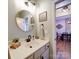 Stylish half-bath with round mirror, modern faucet, and view to dining room at 572 Church St, Locust, NC 28097