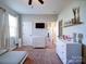 This bedroom offers a white dresser, wall-mounted TV, a window for natural light, and carpet flooring at 572 Church St, Locust, NC 28097