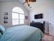 Comfortable bedroom featuring a large arched window, ceiling fan, and a dresser at 572 Church St, Locust, NC 28097