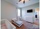 This bedroom features a toddler bed, a white dresser, a wall-mounted TV, and a window for natural light at 572 Church St, Locust, NC 28097