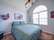 Bright bedroom with large arched window, ceiling fan, and minimalist decor at 572 Church St, Locust, NC 28097