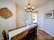 Stylish dining room features a modern chandelier, wood table, and charming decor at 572 Church St, Locust, NC 28097