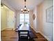 Spacious dining room featuring a wooden table, bench seating, and modern chandelier at 572 Church St, Locust, NC 28097