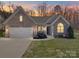 Charming brick home with well-maintained lawn, two-car garage, and inviting front porch at 572 Church St, Locust, NC 28097