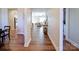 Inviting hallway with beautiful wood flooring and neutral walls leads to the open living area at 572 Church St, Locust, NC 28097