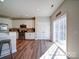 Bright eat-in kitchen features stainless steel appliances, wood floors, and granite countertops at 572 Church St, Locust, NC 28097