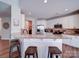 Bright kitchen with white cabinets, stainless steel appliances, and a granite countertop bar at 572 Church St, Locust, NC 28097