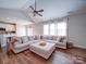 Open living area with a large sectional sofa and a view into the kitchen at 572 Church St, Locust, NC 28097