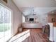 Open living room featuring vaulted ceilings, wood floors, and lots of natural light at 572 Church St, Locust, NC 28097