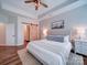 Comfortable main bedroom featuring soft colors, wood floors, and ensuite bathroom at 572 Church St, Locust, NC 28097