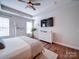 Spacious main bedroom featuring a ceiling fan, wood floors, and natural light at 572 Church St, Locust, NC 28097