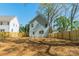 Back exterior of home and fenced-in yard showing siding, windows, and plenty of outdoor space at 574 Reid St, Belmont, NC 28012