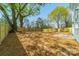Large backyard featuring a new wooden fence and a lush tree canopy for shade and privacy at 574 Reid St, Belmont, NC 28012