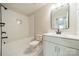 Bathroom featuring a tiled shower-tub, and a vanity with a sink and a large mirror at 574 Reid St, Belmont, NC 28012