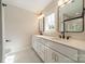 Bright bathroom featuring double sinks with white cabinets and modern fixtures at 574 Reid St, Belmont, NC 28012
