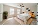 Sun-drenched bedroom featuring neutral tones, ceiling fan, and bright windows at 574 Reid St, Belmont, NC 28012