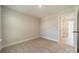 Bright bedroom with neutral walls, plush carpeting, and an open doorway to an adjacent room at 574 Reid St, Belmont, NC 28012