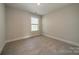 Empty bedroom showcasing neutral carpet, natural light, and a bright atmosphere at 574 Reid St, Belmont, NC 28012