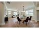 Elegant dining room featuring a glass table, modern chandelier, and natural light from large windows at 574 Reid St, Belmont, NC 28012